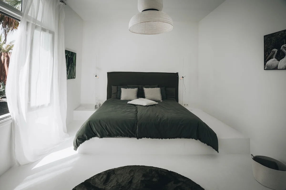 A second bedroom with a built-in bed and soft green accents.