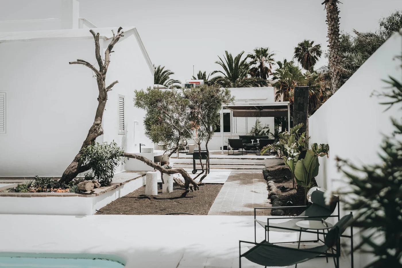 A garden path, white walls and sheltered places to sit.