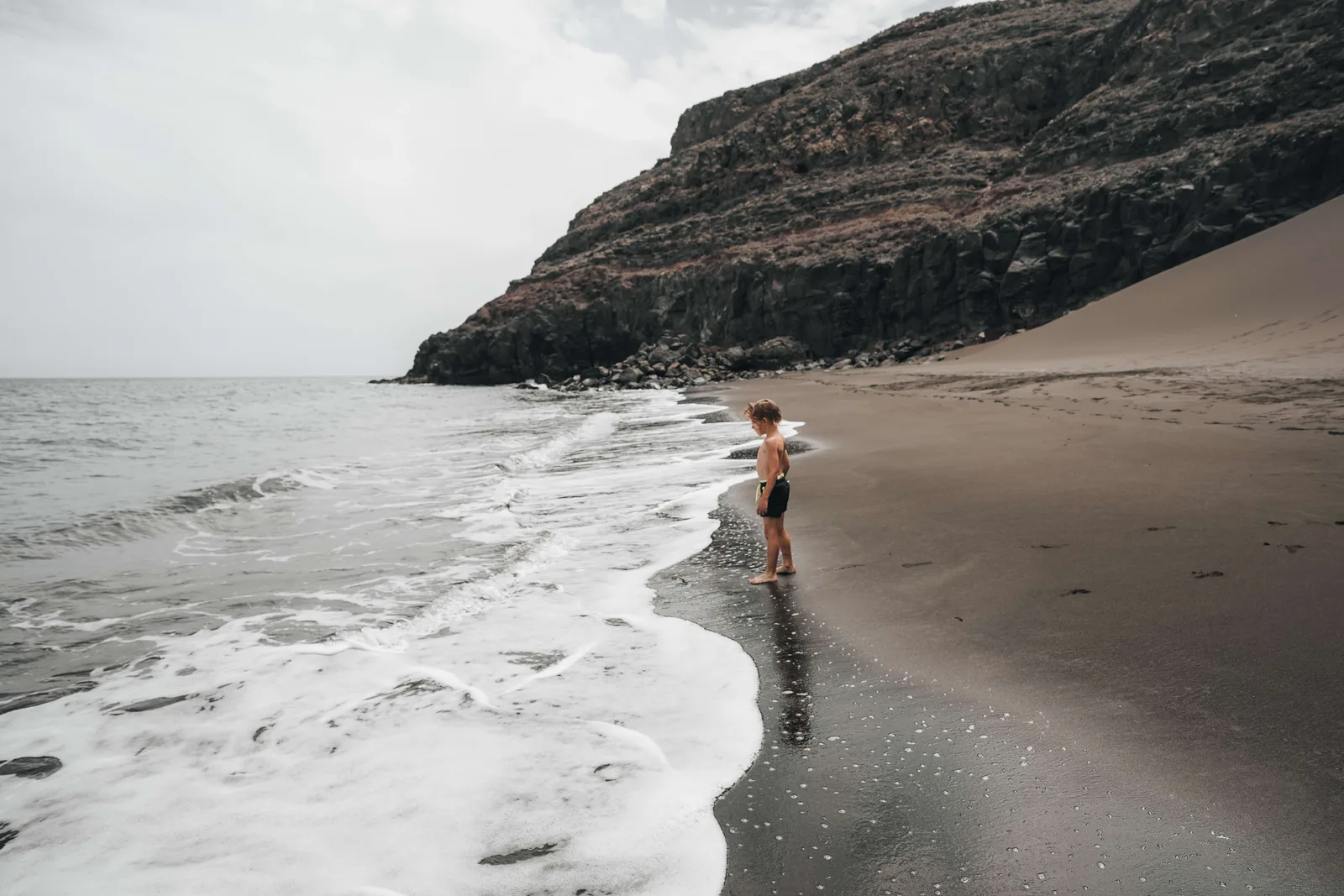 Waves meeting the black-sand beach at Playa Quemada.