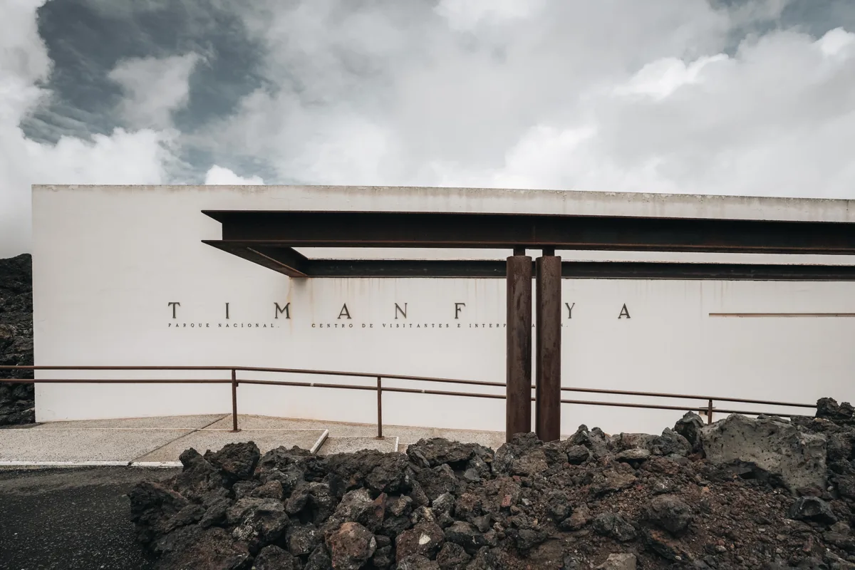 White walls of the Timanfaya visitor centre among dark lava.